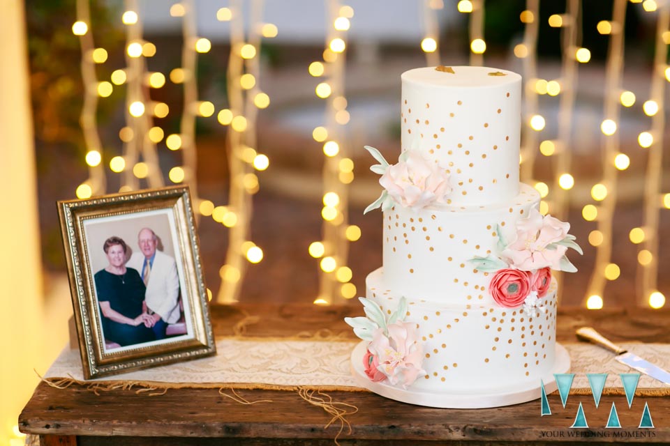 Bides parents photo next to the wedding cake