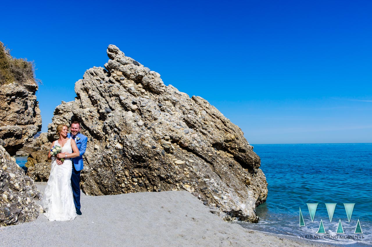 Nerja beach wedding photographer with the bride and groom