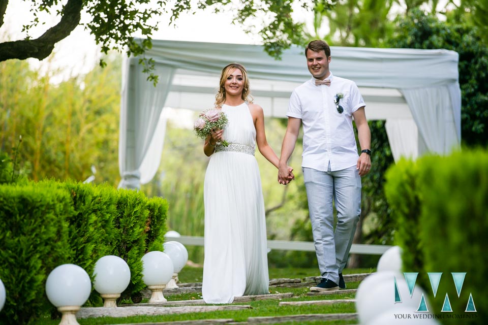 Bride and groom walking down garden in Finca Villa Palma near Marbella
