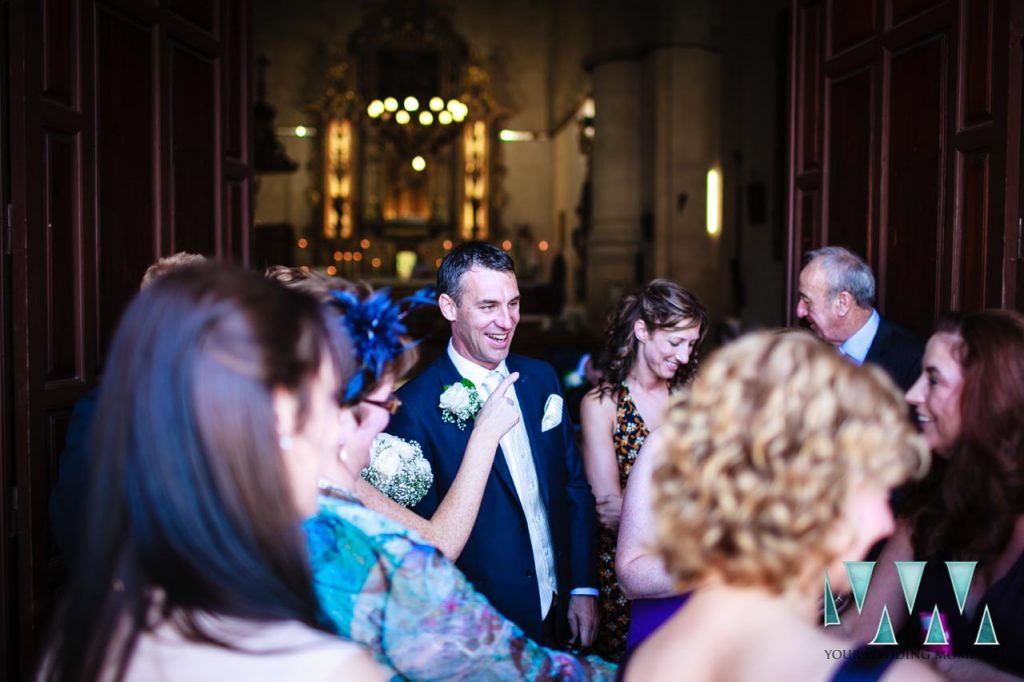 Happy groom waiting outside church in Ronda