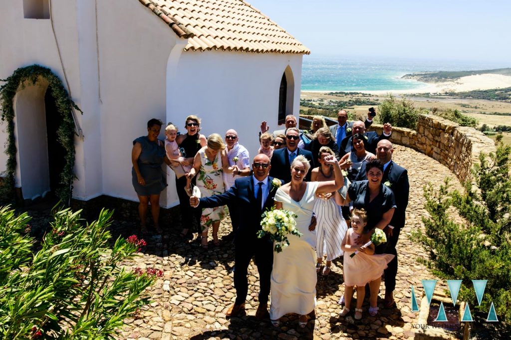 Wedding group shot with the beaches of Tarifa in the background