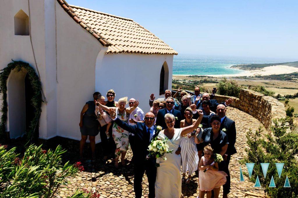 Wedding group shot with the beaches of Tarifa in the background