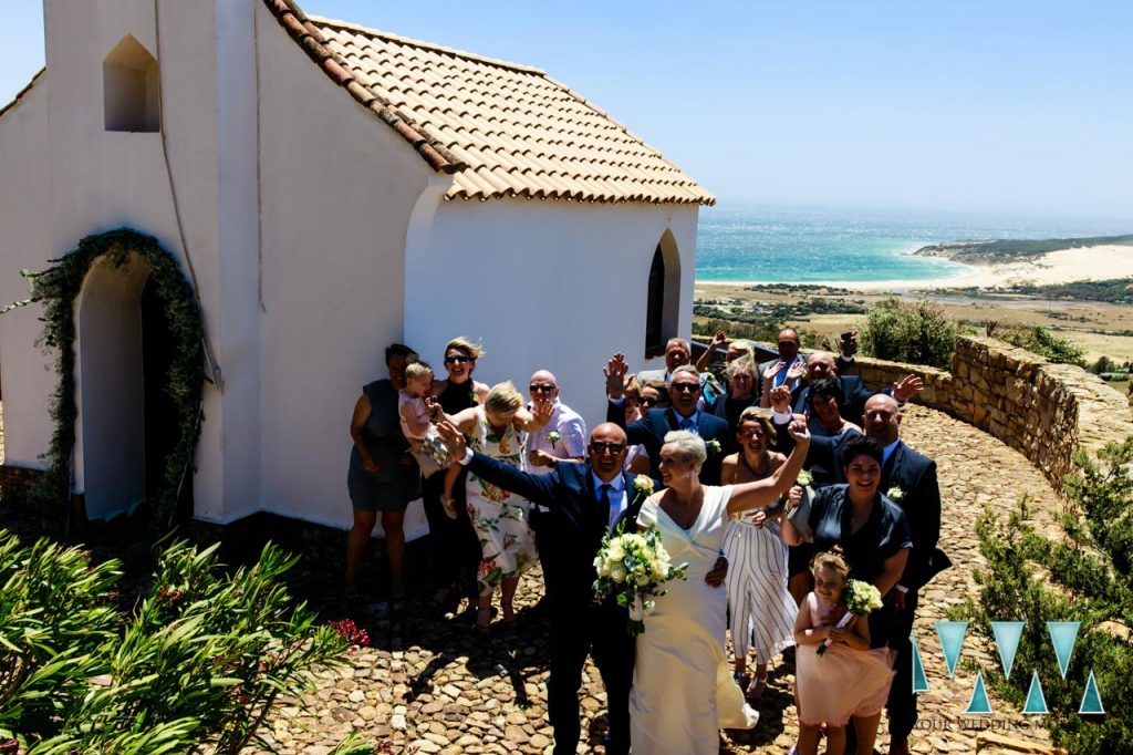 Wedding group shot with the beaches of Tarifa in the background