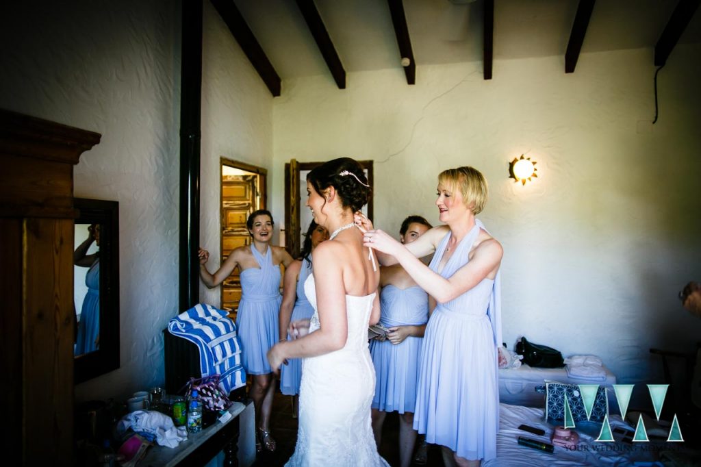 Rancho Del Ingles Wedding bride putting on the dress