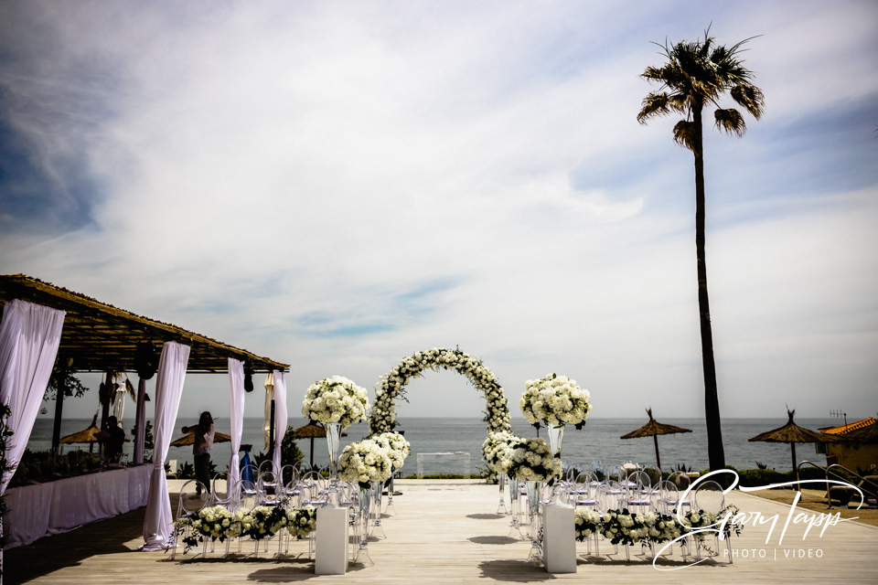 Wedding ceremony chairs and flowers setup at the Finca Cortesin Beach Club
