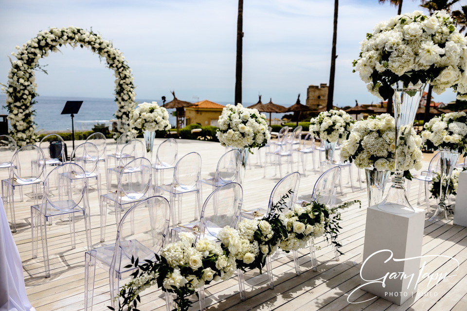 Wedding ceremony flower arch, chairs and decoration setup at the Finca Cortesin Beach Club