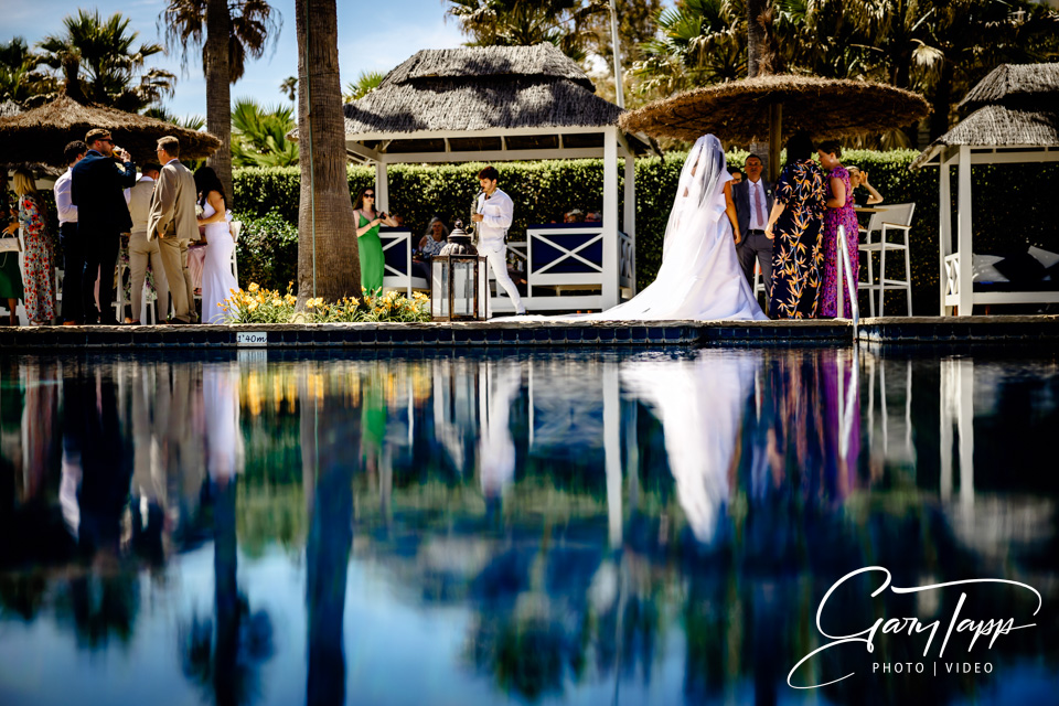 Finca Cortesin Wedding Photographer 6 Brides reflection at the Finca Cortesin Beach Club pool