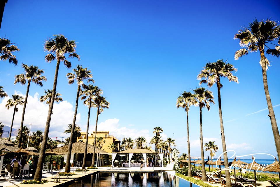 Finca Cortesin Wedding Photographer 5 Beach Clubs pool and palm trees oposite the coast