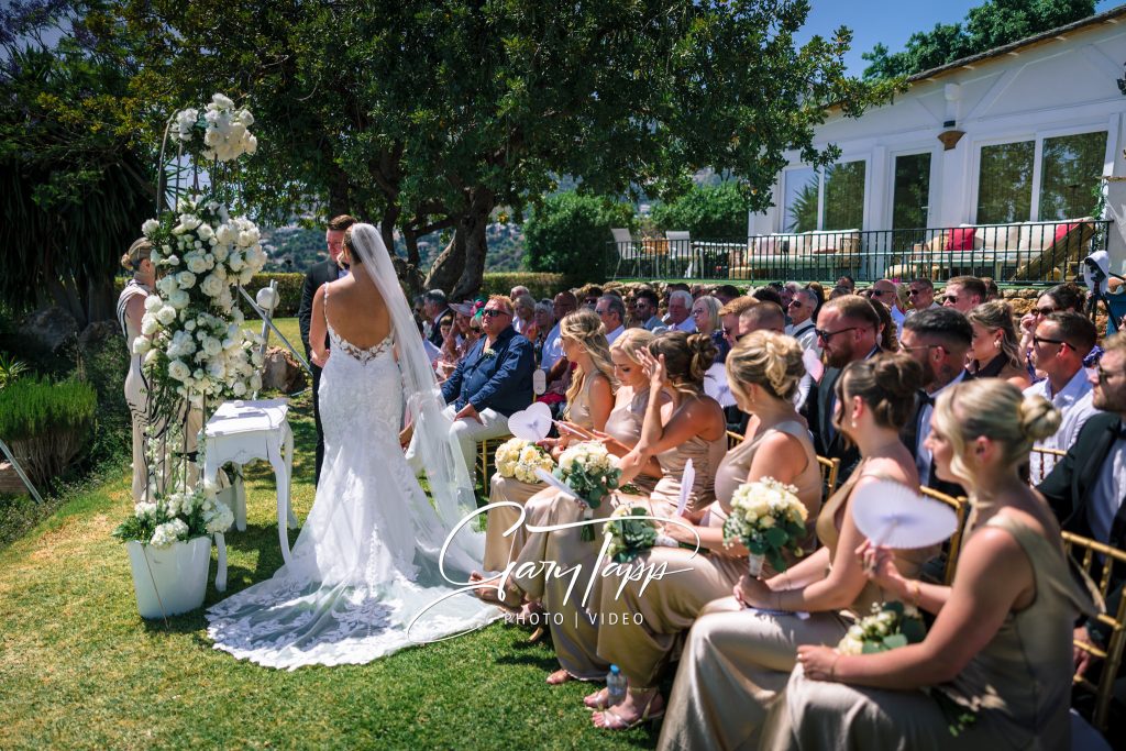 Finca Bella Vista Wedding Photographer | Mijas, Andalucia 3 Bride and grrom in front of the wedding arch at the Finca Bella Vista wedding venue