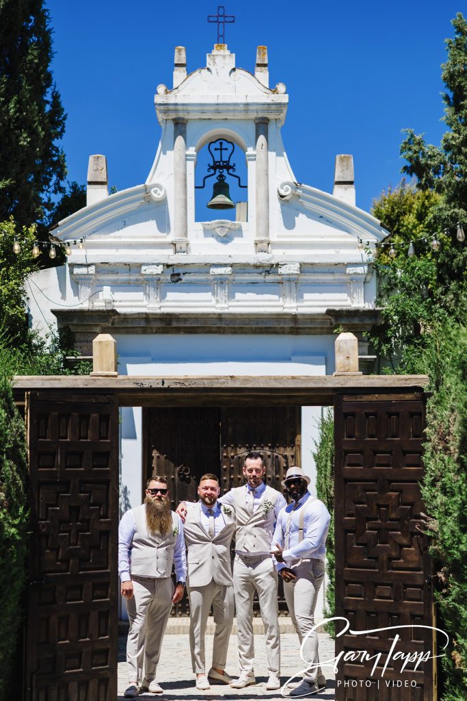 Groomsmen at the entrance of Finca Monasterio